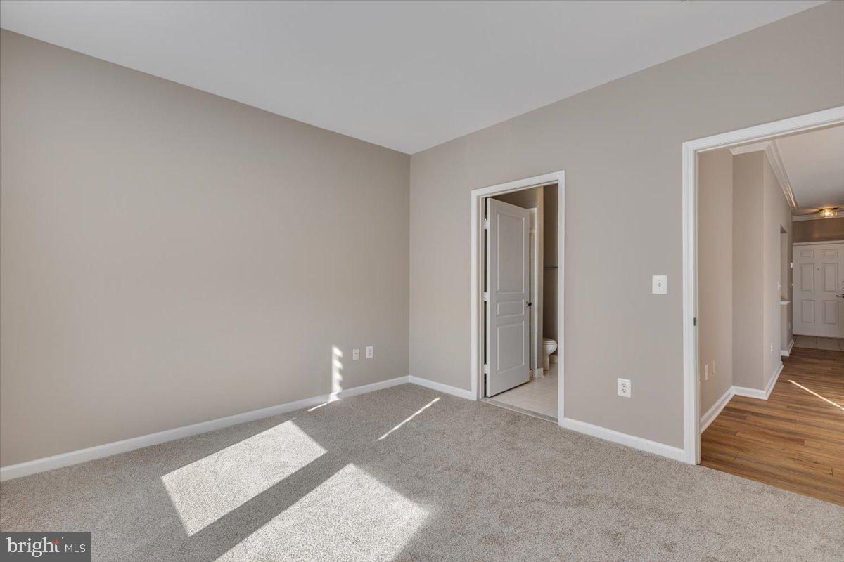 12001 Market Street, Unit 257 Reston, VA 20190 - Photo 20 of 33 a view of a room with an empty space and wooden floor