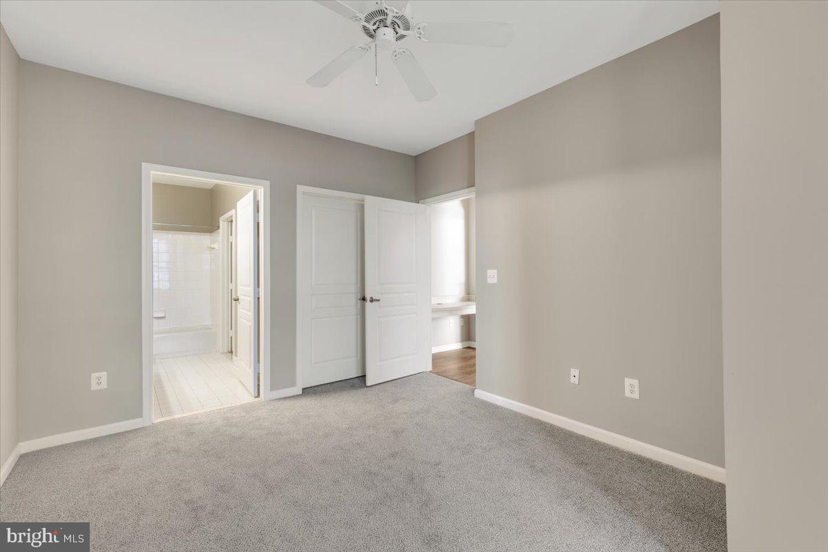 12001 Market Street, Unit 257 Reston, VA 20190 - Photo 21 of 33 a view of an empty room and a chandelier fan