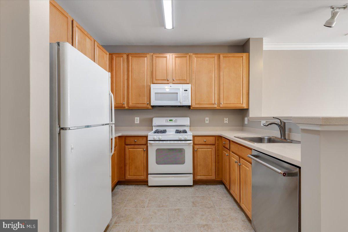 12001 Market Street, Unit 257 Reston, VA 20190 - Photo 3 of 33 a kitchen with stainless steel appliances granite countertop a refrigerator sink and stove