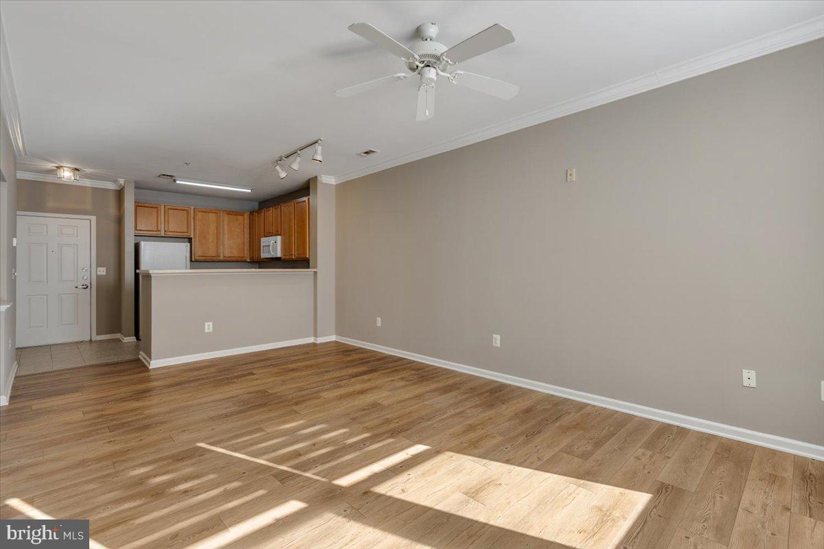 12001 Market Street, Unit 257 Reston, VA 20190 - Photo 6 of 33 a view of a kitchen with a dishwasher and a white cabinets
