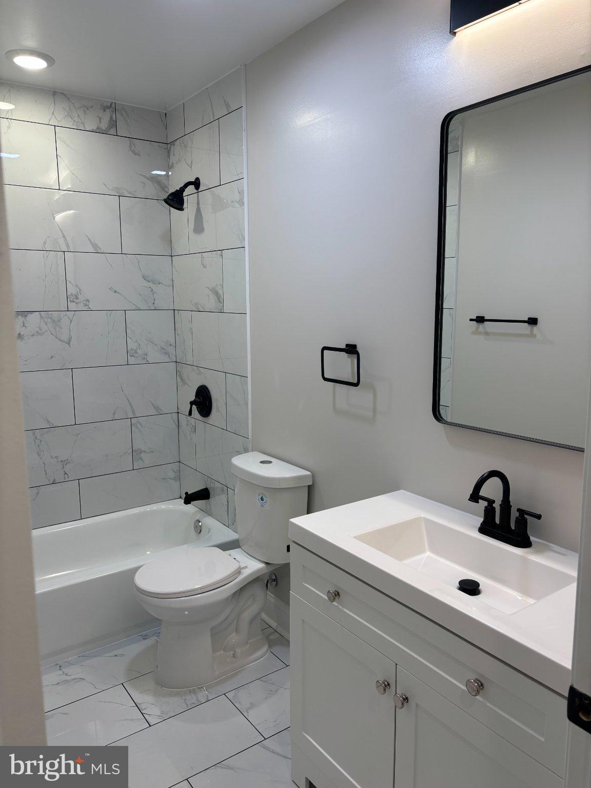 4818 Pimlico Road Baltimore, MD 21215 - Photo 18 of 18 a bathroom with a sink toilet and shower