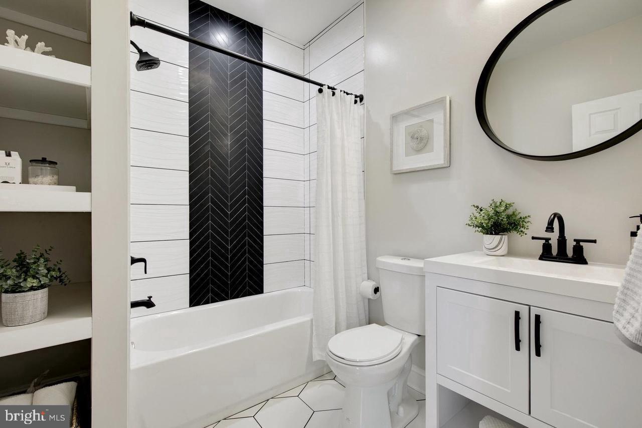 4818 Pimlico Road Baltimore, MD 21215 - Photo 5 of 18 a bathroom with a sink toilet and shower