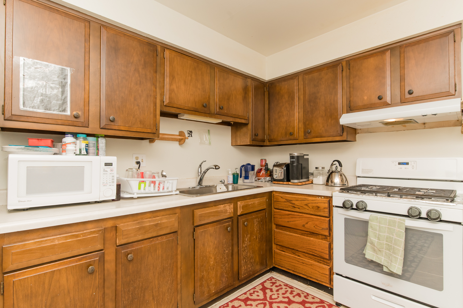 765 Terrace Court, Unit 206 Elgin, IL 60120 - Photo 11 of 31 a kitchen with stainless steel appliances granite countertop a sink stove and cabinets