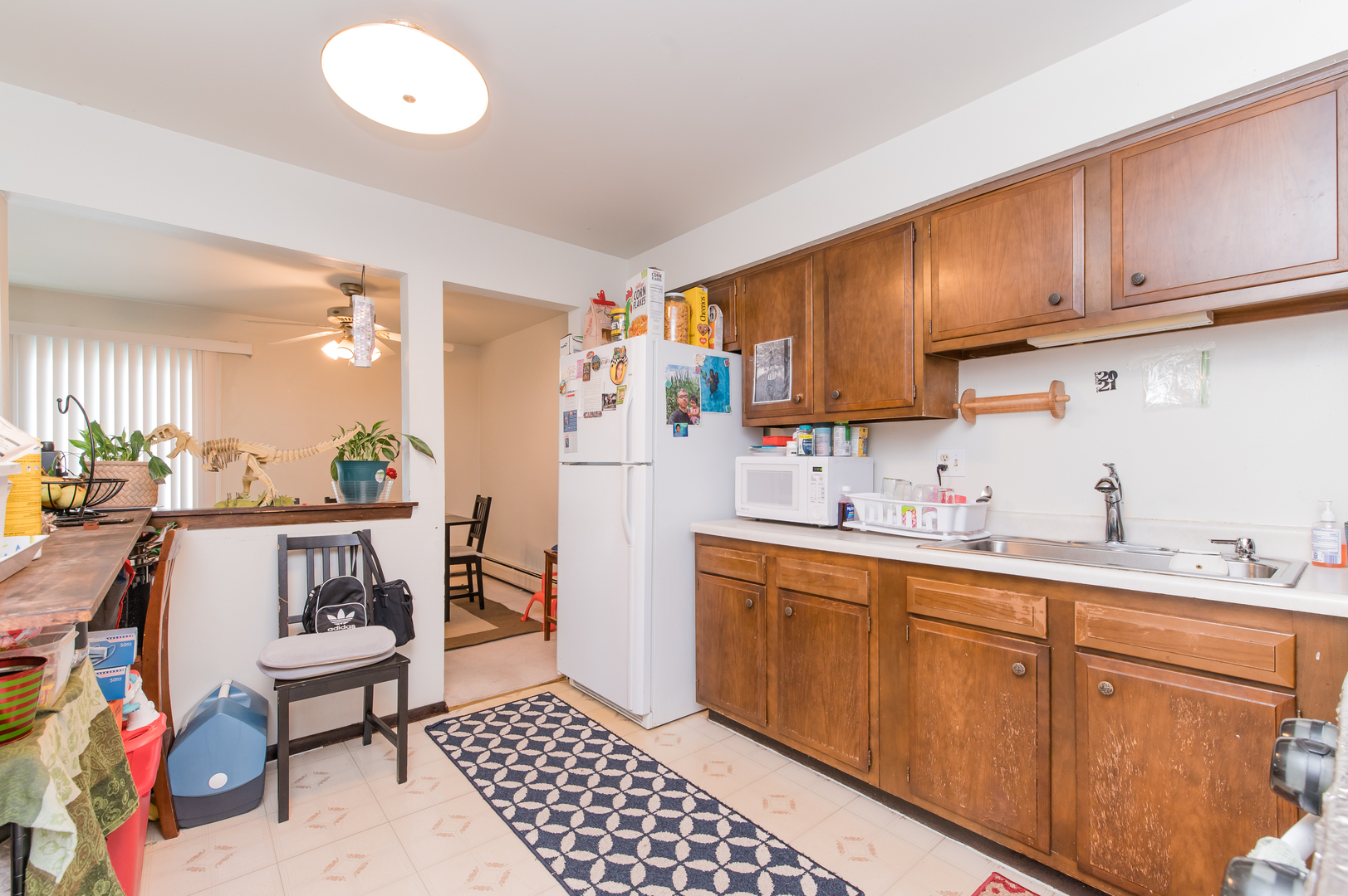 765 Terrace Court, Unit 206 Elgin, IL 60120 - Photo 12 of 31 a kitchen with stainless steel appliances a sink cabinets and wooden floor