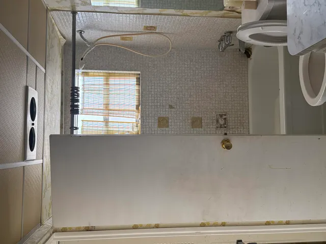 a bathroom with a bathtub and a window