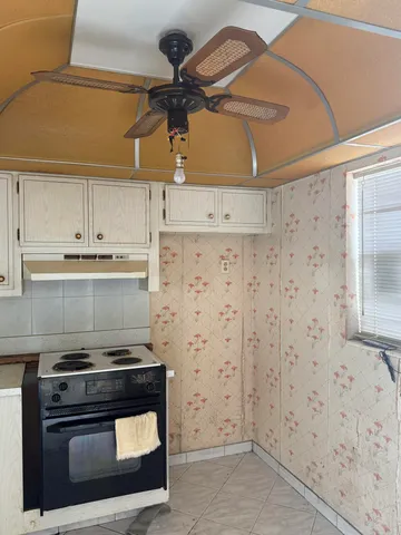 a stove top oven sitting inside of a kitchen