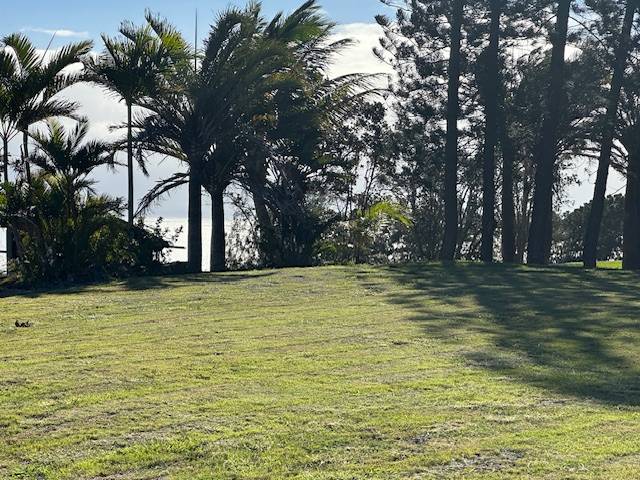 Lovely mowed grassed square shaped lot with golf course and ocean view