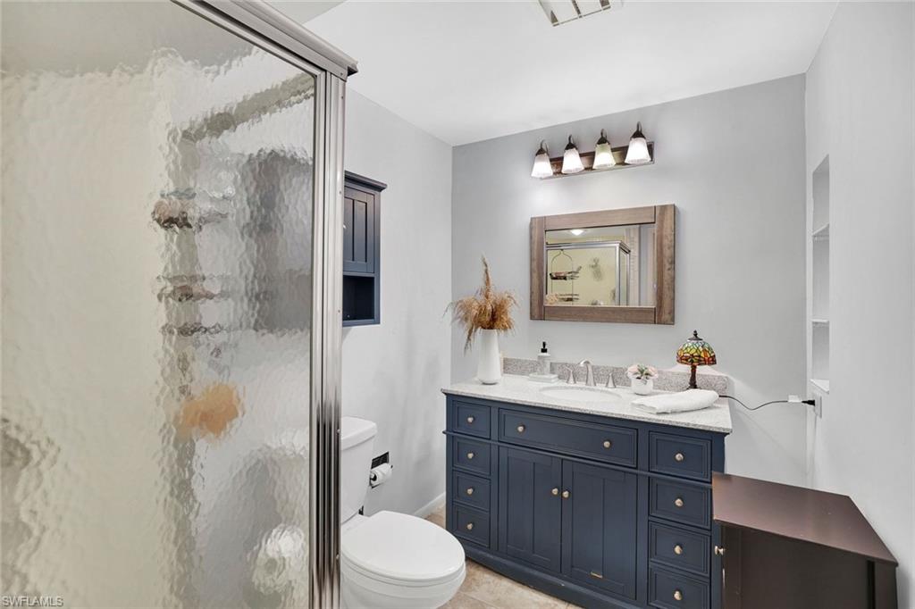 208 Baltusrol Drive Naples, FL 34113 - Photo 15 of 25 1st guest bathroom, full bathroom with walk-in shower