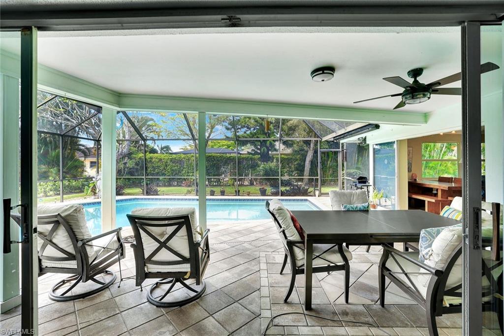 208 Baltusrol Drive Naples, FL 34113 - Photo 19 of 25 Looking from great room to outdoor area