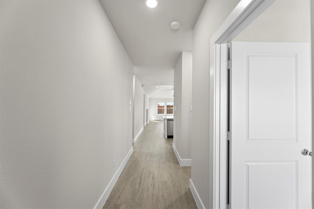 2359 Bell Way Forney, TX 75126 - Photo 21 of 31 a view of a hallway with a wooden floor