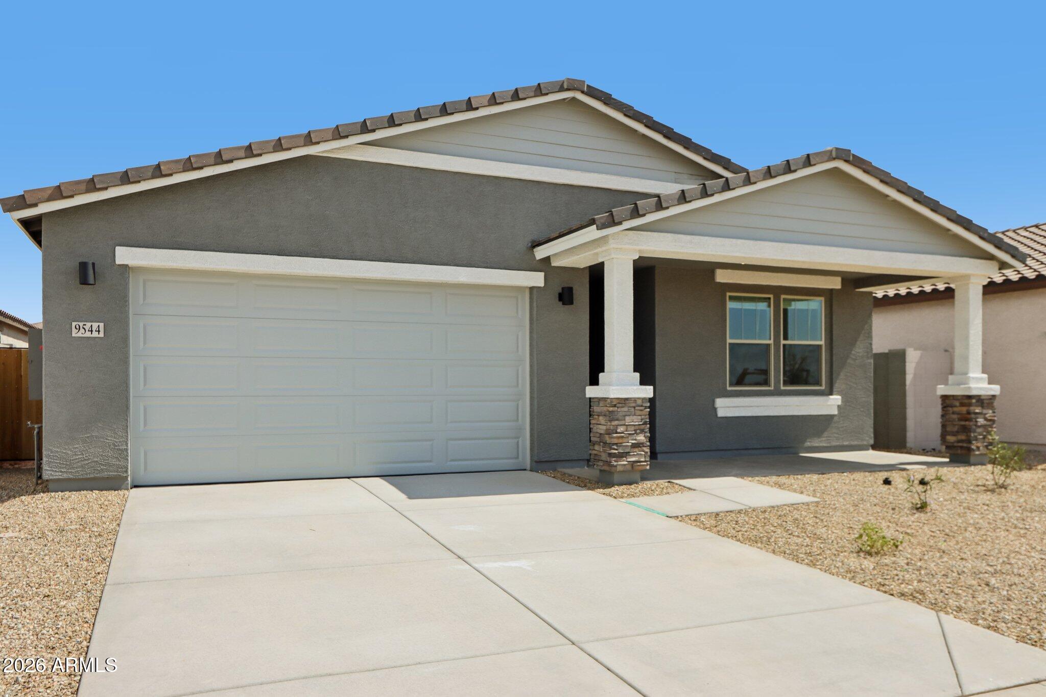 9544 West Gaby Road Tolleson, AZ 85353 - Photo 2 of 43 a front view of a house with a yard