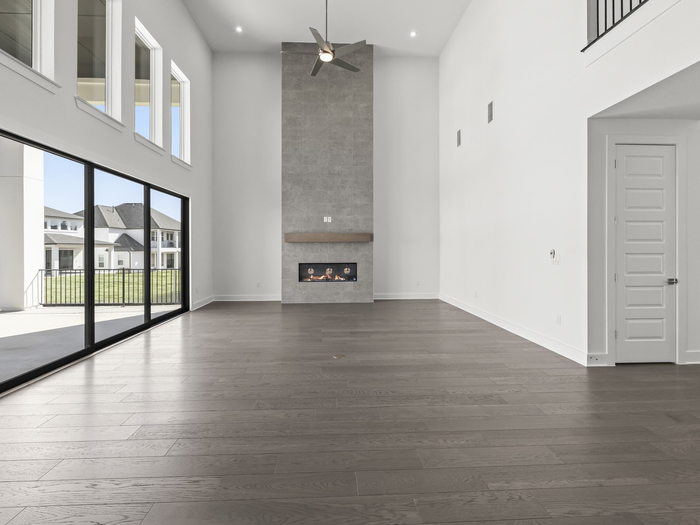2508 Chiavari Way Leander, TX 78641 - Photo 3 of 24 Floor-to-ceiling windows and a sleek fireplace create a bright, inviting living space.