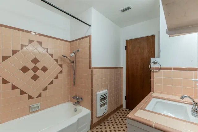 a bathroom with a bathtub and shower