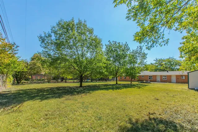 a view of a swimming pool with a yard