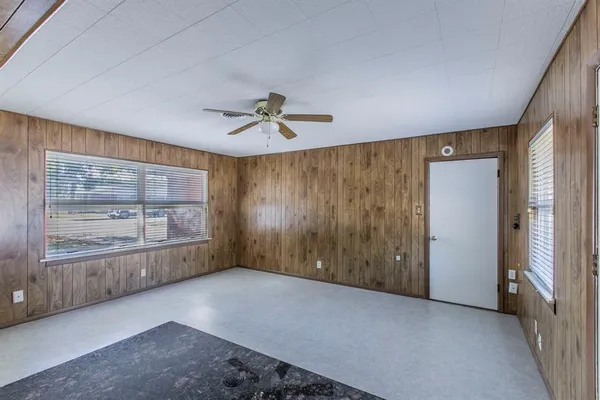 an empty room with a empty space and windows