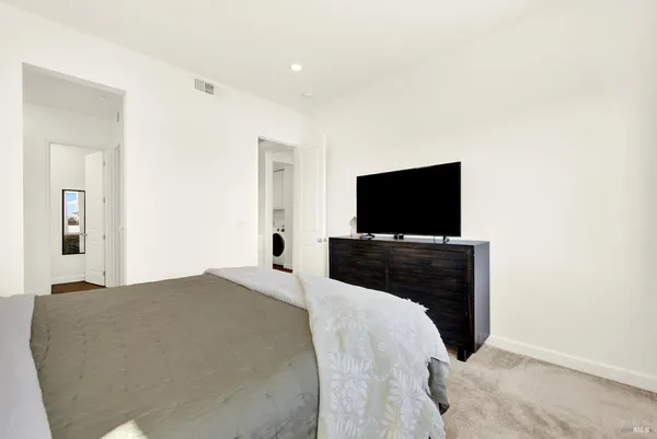 a bedroom with a bed and a flat screen tv