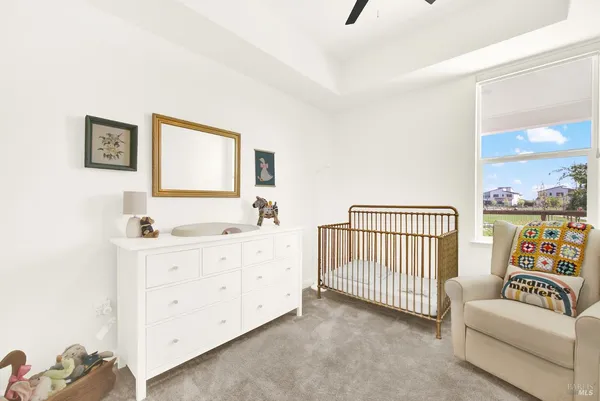 a view of a bedroom with furniture and window