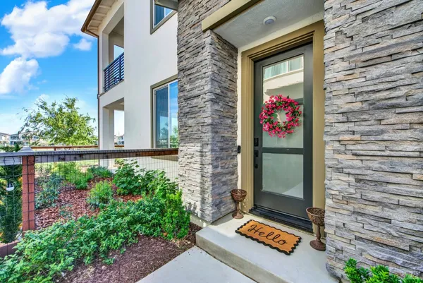 a front view of a house with a garden