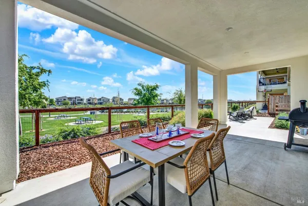 a view of a dining table and chairs in the patio