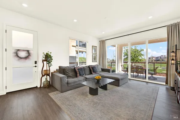 a living room with furniture and large windows