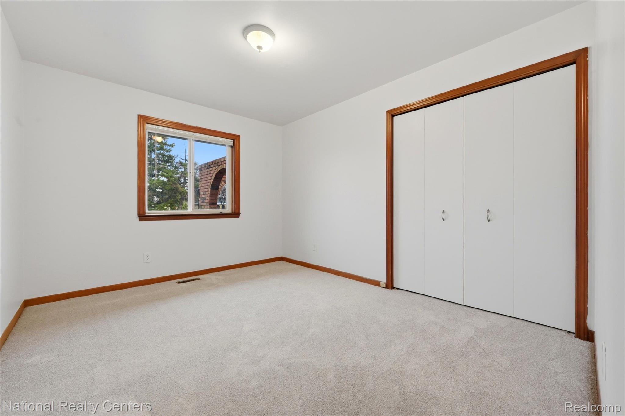 37625 Ryan Road Sterling Heights, MI 48310 - Photo 17 of 30 Unfurnished bedroom with light carpet and a closet