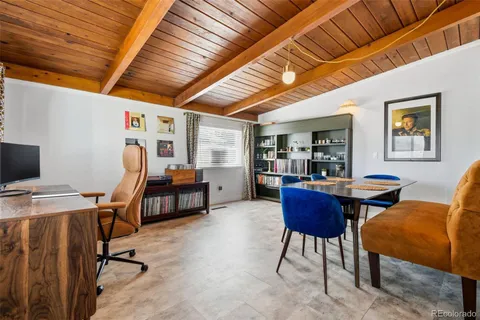 a view of a livingroom with furniture and a workspace