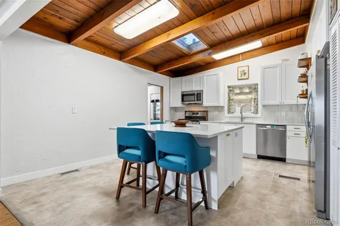 a kitchen with a sink cabinets and window
