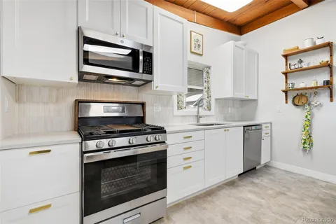 a kitchen with cabinets stainless steel appliances and a counter top space