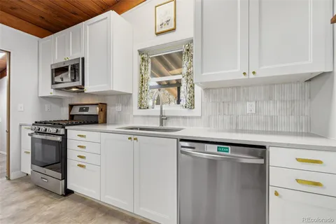 a kitchen with cabinets appliances and a sink