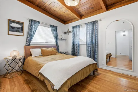 a bedroom with a bed and a mirror