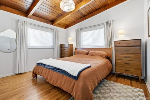 a bed sitting in a bedroom next to a window