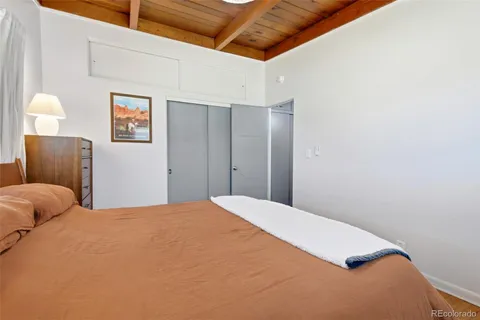 a bedroom with a bed and a couch