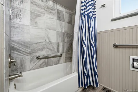 a bathroom with a bathtub and a shower