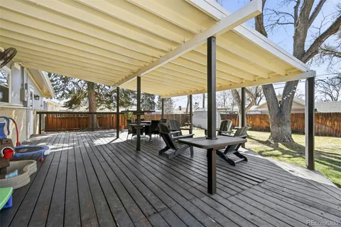 a view of a patio with chairs and wooden floor