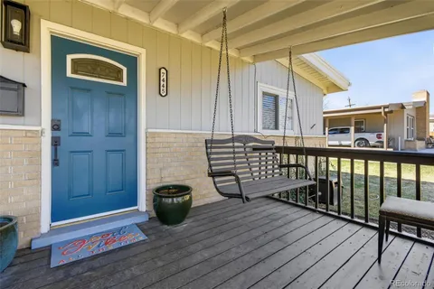 a view of a balcony with chairs and wooden floor