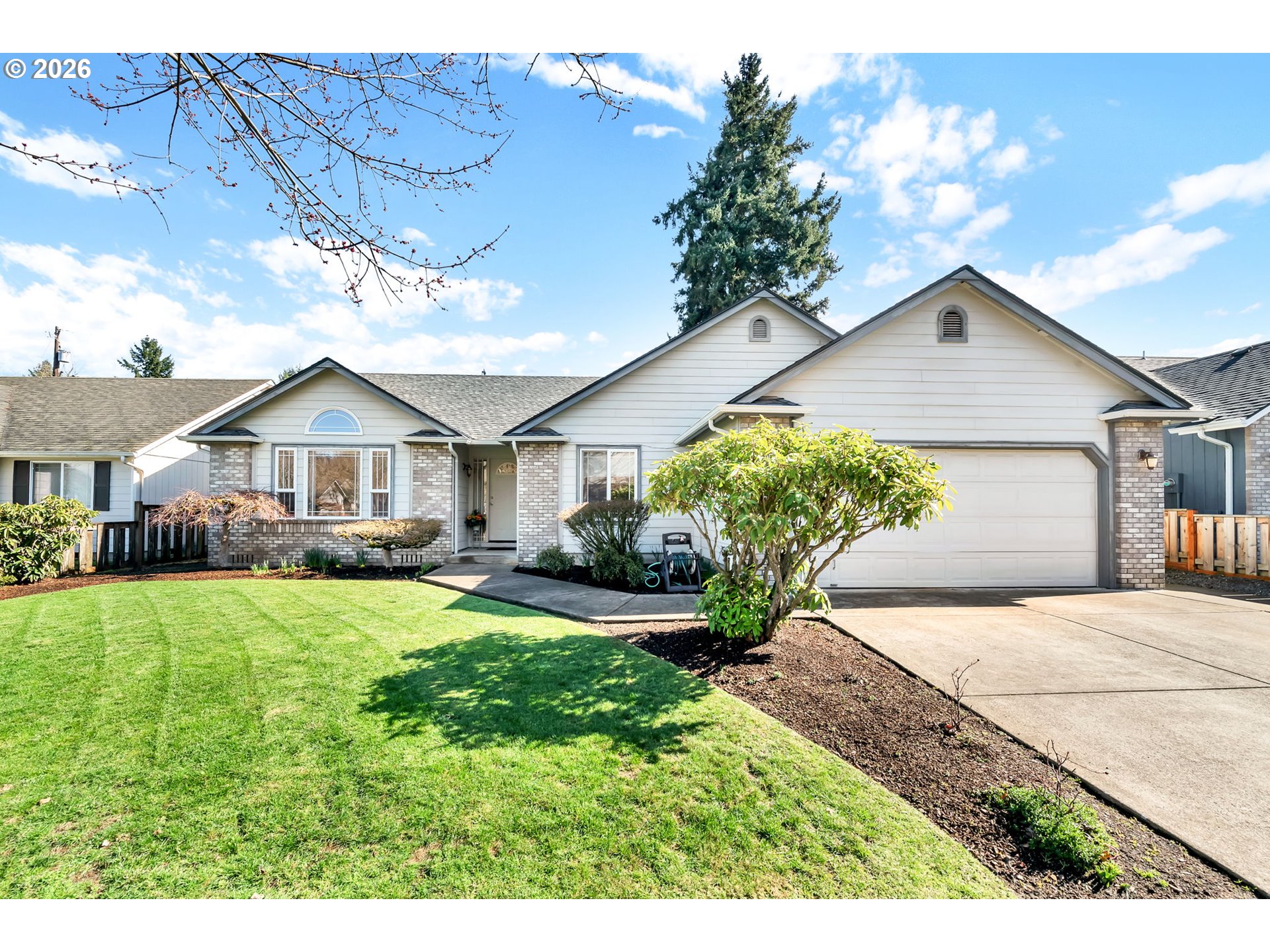 4471 Spring Meadow Avenue Eugene, OR 97404 - Photo 1 of 31 a front view of a house with a yard and porch
