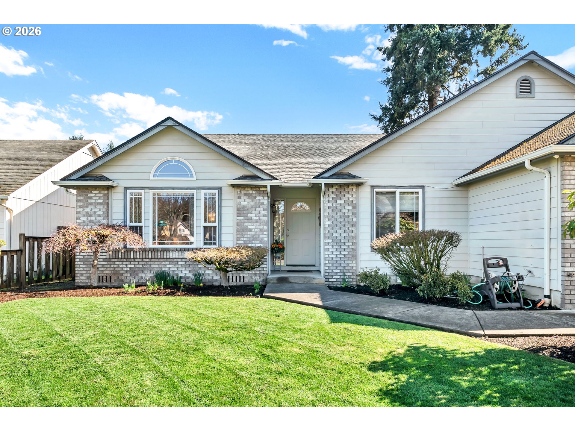 4471 Spring Meadow Avenue Eugene, OR 97404 - Photo 2 of 31 a front view of a house with a garden and yard