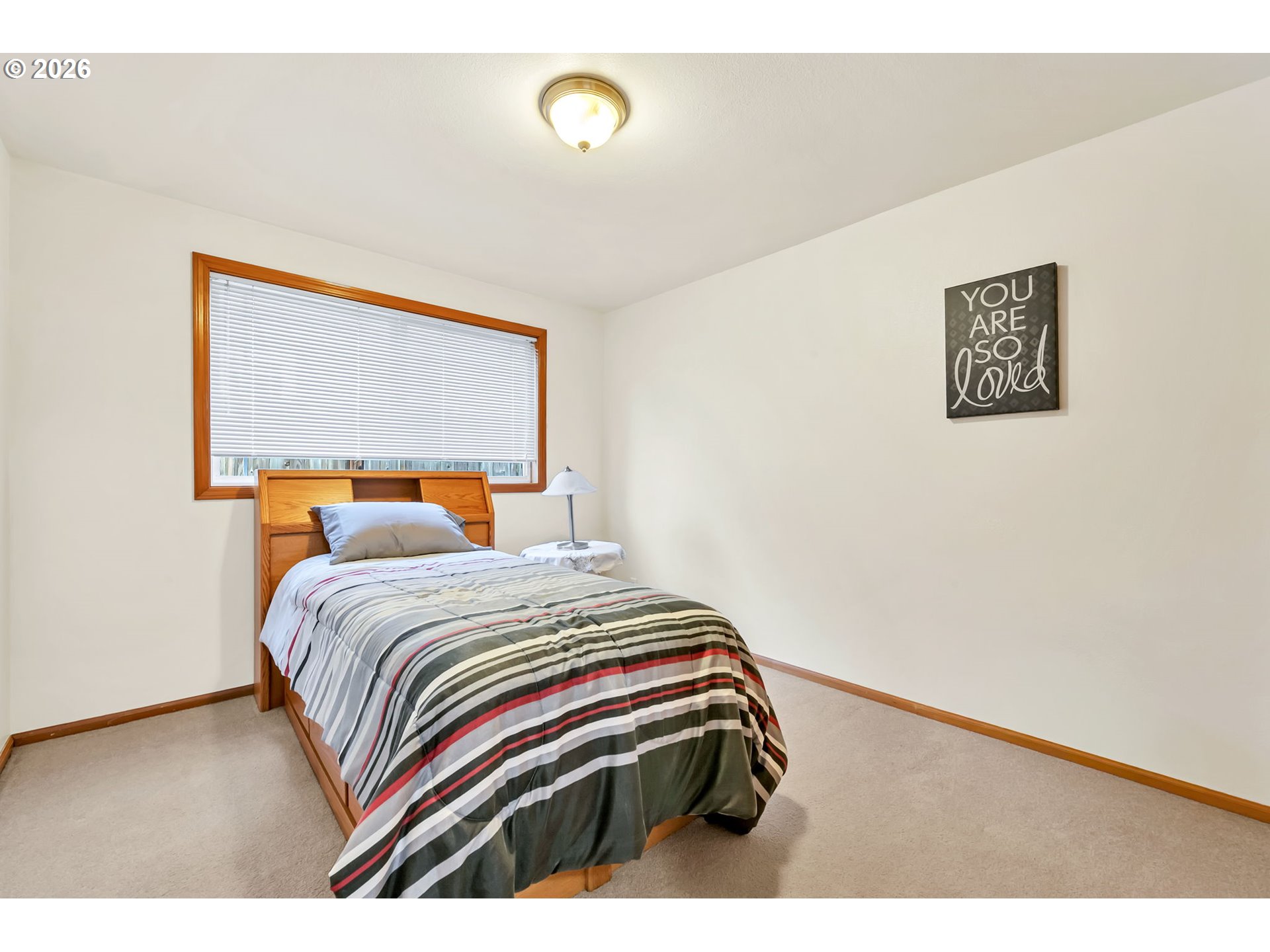 4471 Spring Meadow Avenue Eugene, OR 97404 - Photo 24 of 31 a bedroom with a bed and a painting on the wall