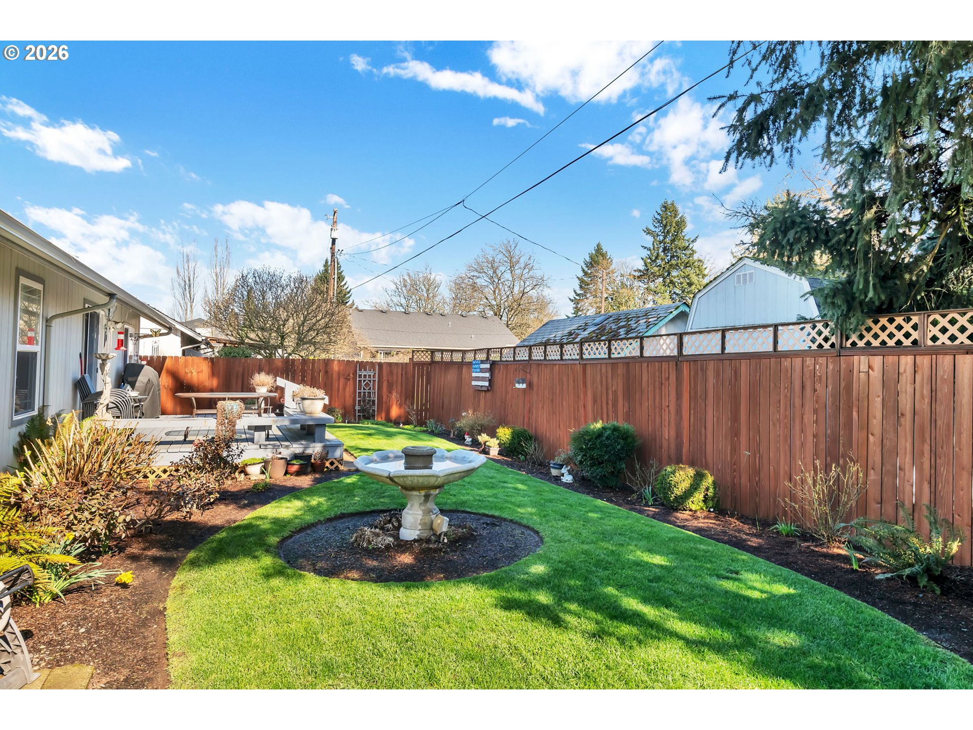 4471 Spring Meadow Avenue Eugene, OR 97404 - Photo 29 of 31 a view of a backyard with plants and a patio