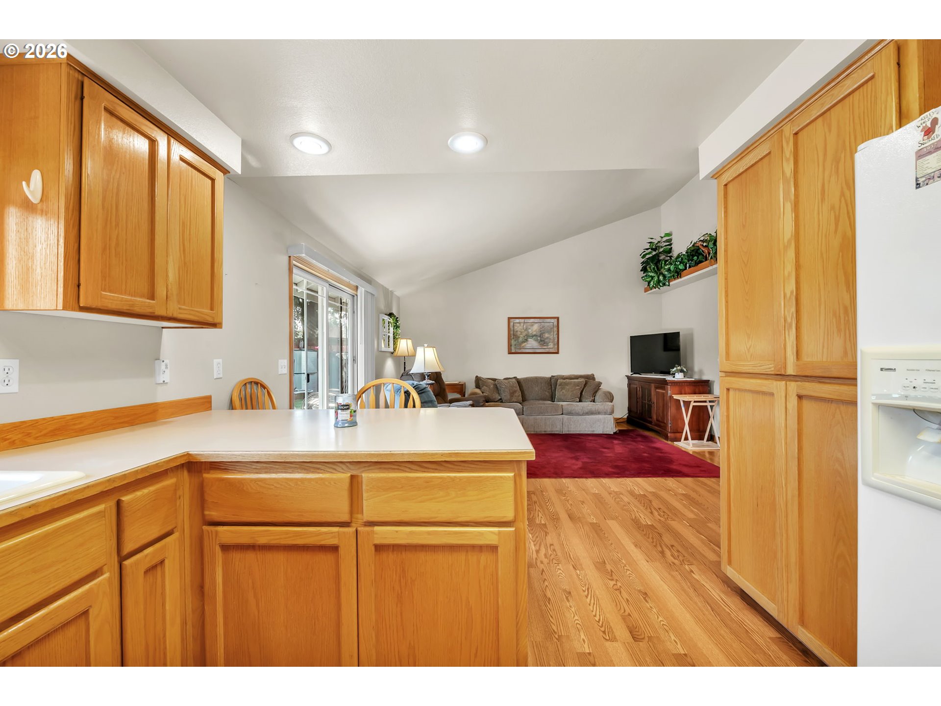 4471 Spring Meadow Avenue Eugene, OR 97404 - Photo 9 of 31 a kitchen with kitchen island granite countertop cabinets and refrigerator