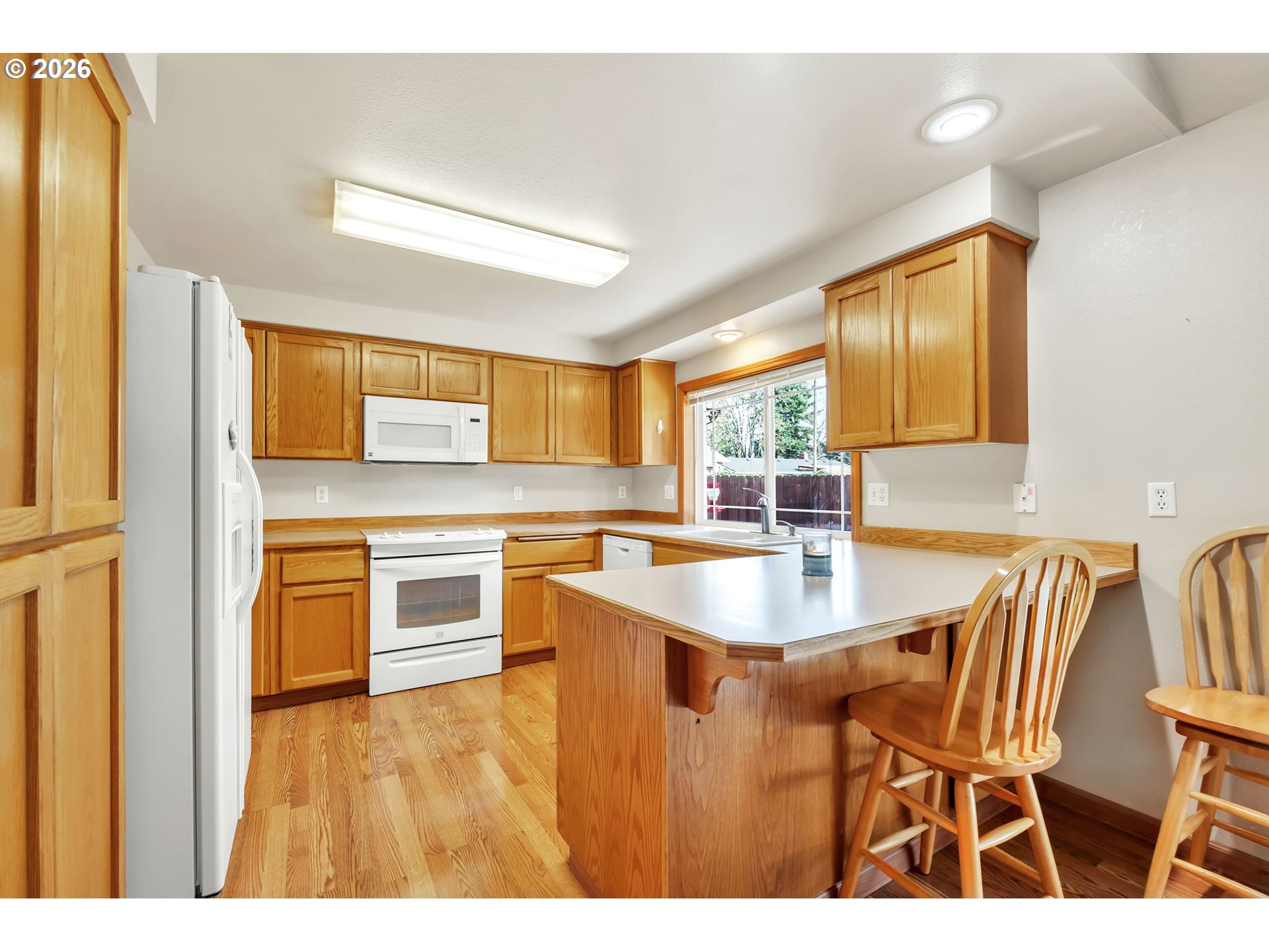4471 Spring Meadow Avenue Eugene, OR 97404 - Photo 10 of 31 a kitchen with stainless steel appliances granite countertop a sink and a refrigerator