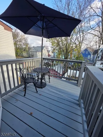 a view of a balcony with furniture and wooden floor