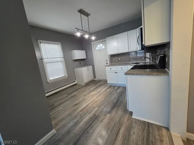 a view of a kitchen with electric appliances