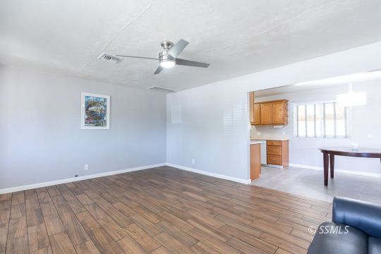 240 West Graaf Avenue Ridgecrest, CA 93555 - Photo 9 of 28 a view of empty room with wooden floor and fan