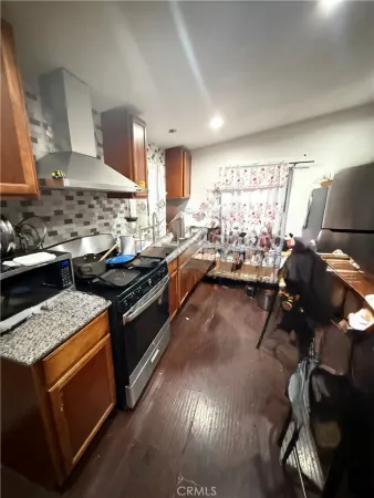 a kitchen with stainless steel appliances granite countertop a stove and a refrigerator