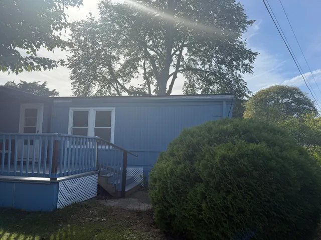 a view of backyard with tub and trees