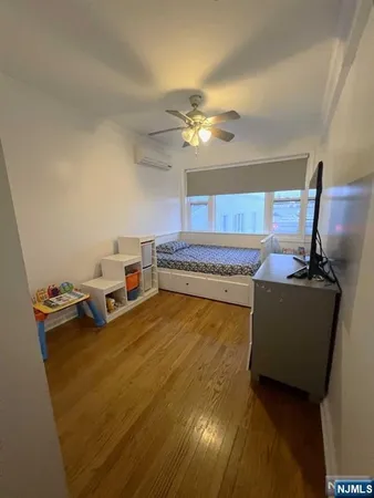 a living room with a bed furniture and a chandelier