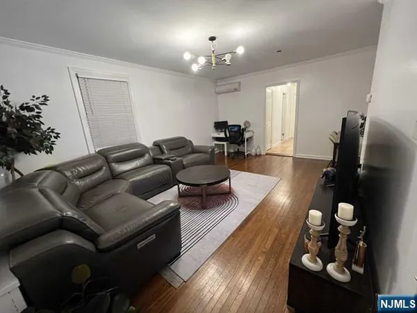 a living room with furniture and a chandelier
