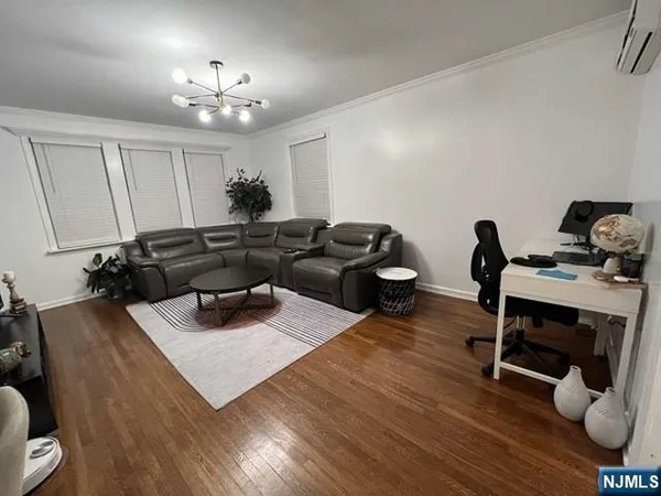 a living room with furniture and a chandelier
