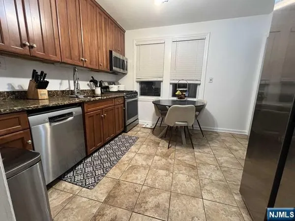 a kitchen with a sink a stove and cabinets